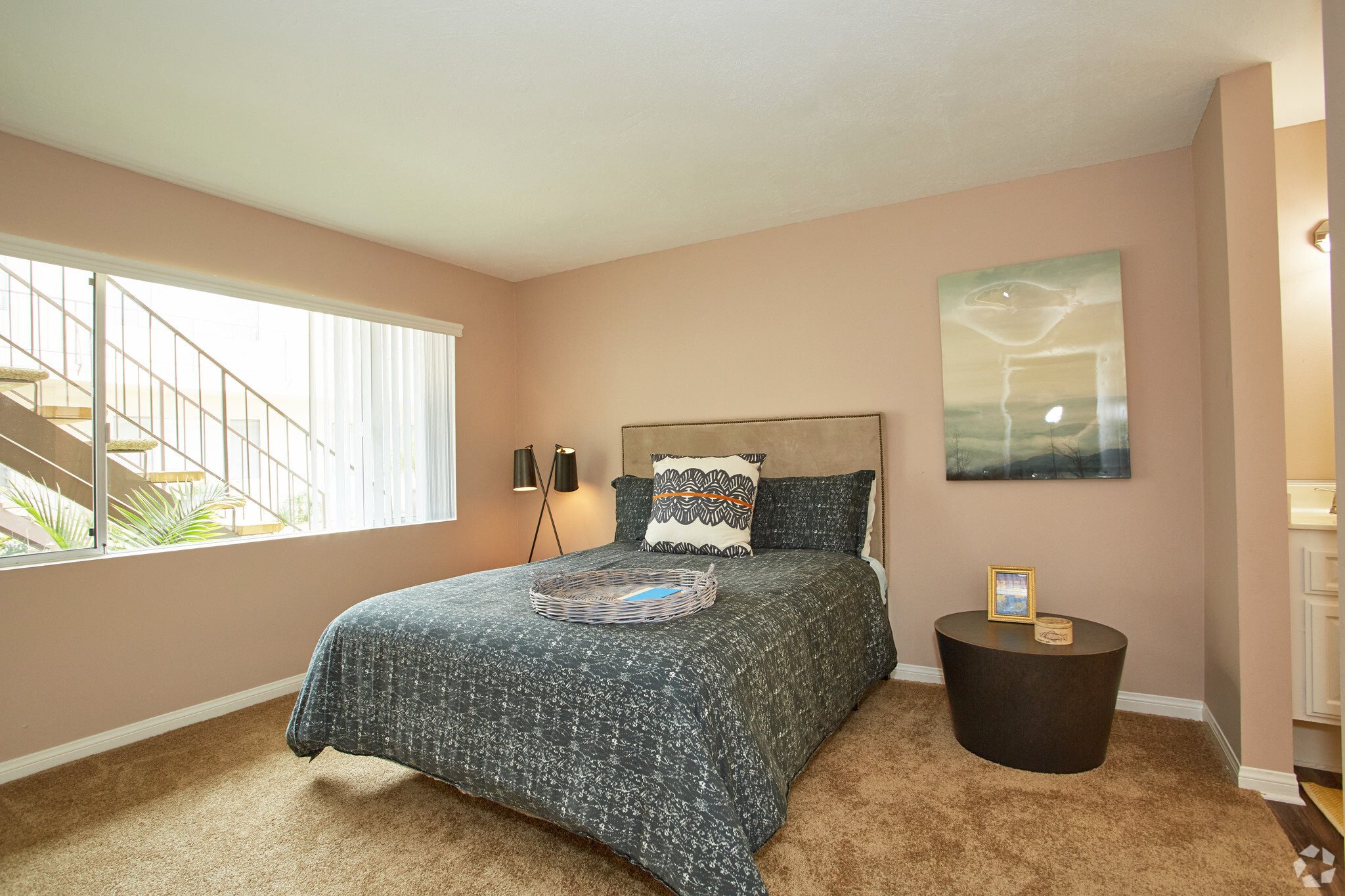a bedroom with a bed and a window